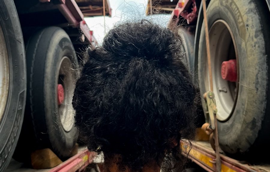 the back of a woman's head as she sits in front of a truck