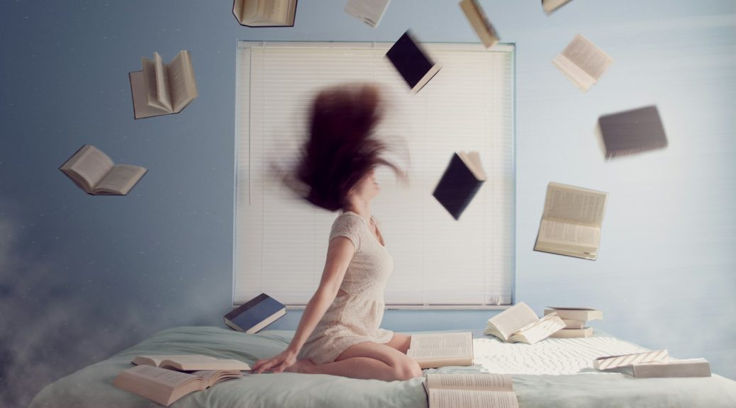 woman sitting on bed with flying books